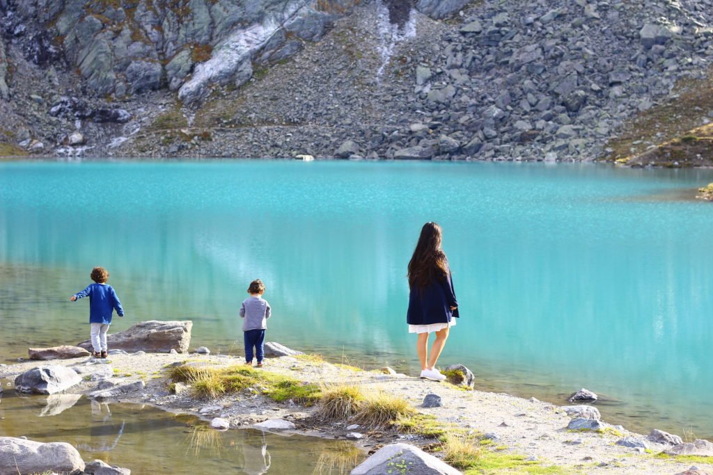 blue lake and three persons